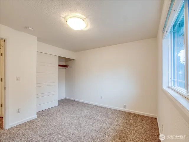 an empty room with a empty space and windows