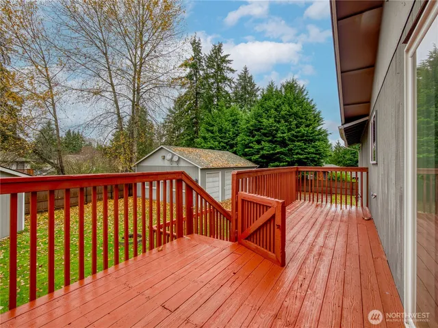 a view of balcony with wooden floor and fence