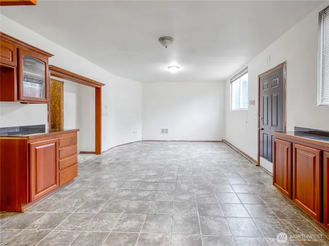 a view of an empty room with a kitchen