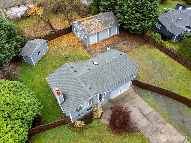 an aerial view of a house with garden space and street view
