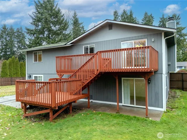 a view of a small house with a deck