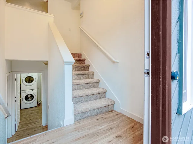 a view of entryway and hall with wooden floor
