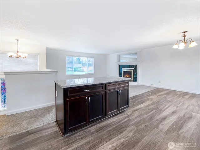 a kitchen with granite countertop a stove and cabinets