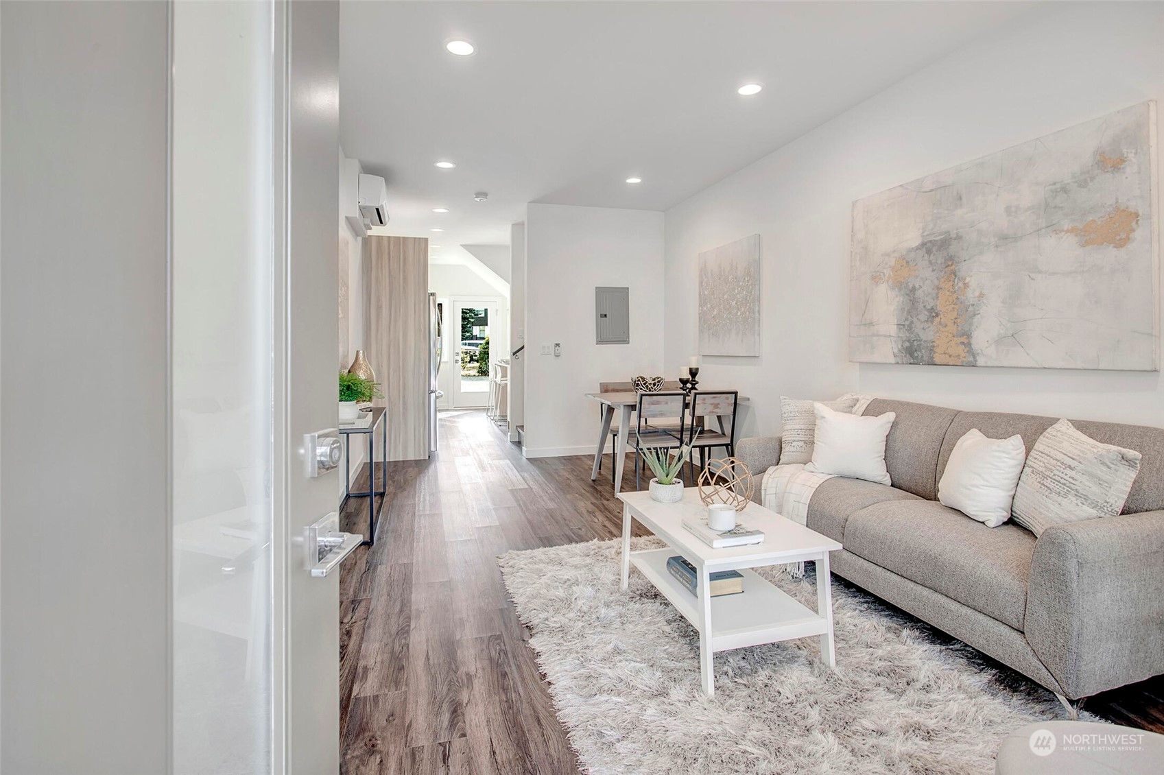 10170 Holman Road Northwest, Unit A Seattle, WA 98133 - Photo 2 of 13 a living room with furniture and a wooden floor