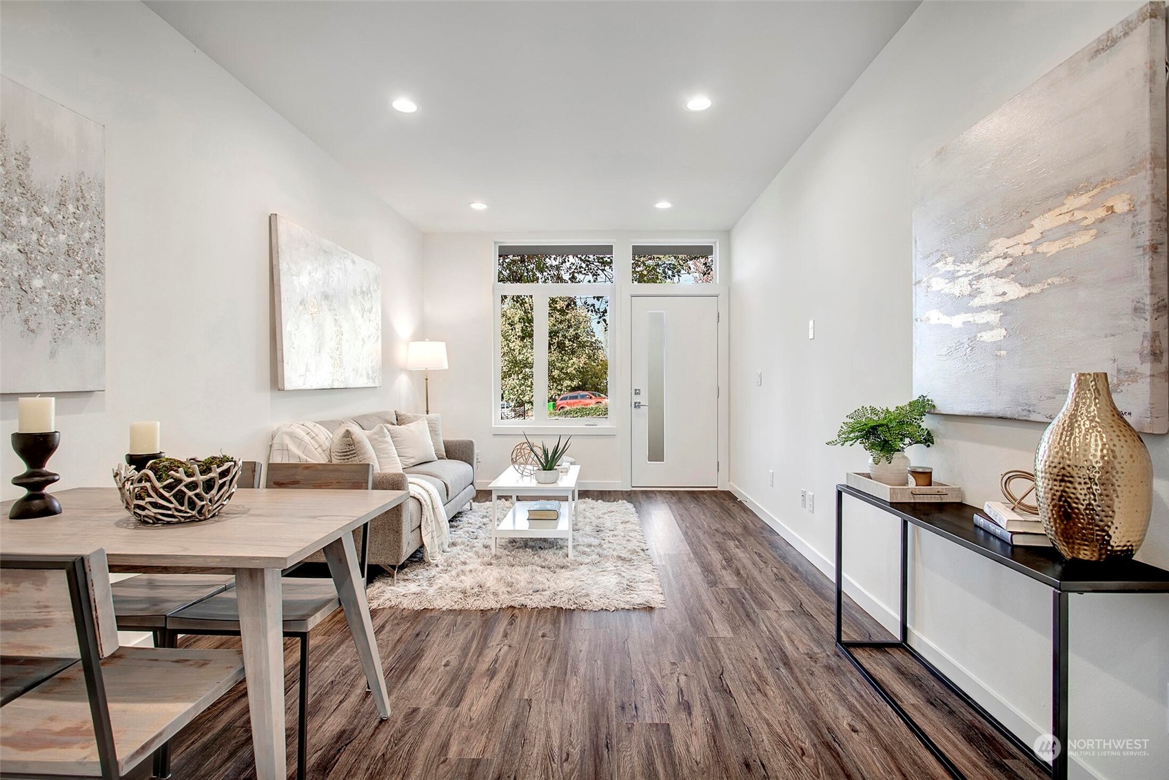 10170 Holman Road Northwest, Unit A Seattle, WA 98133 - Photo 4 of 13 a view of a a dining room with furniture window and wooden floor