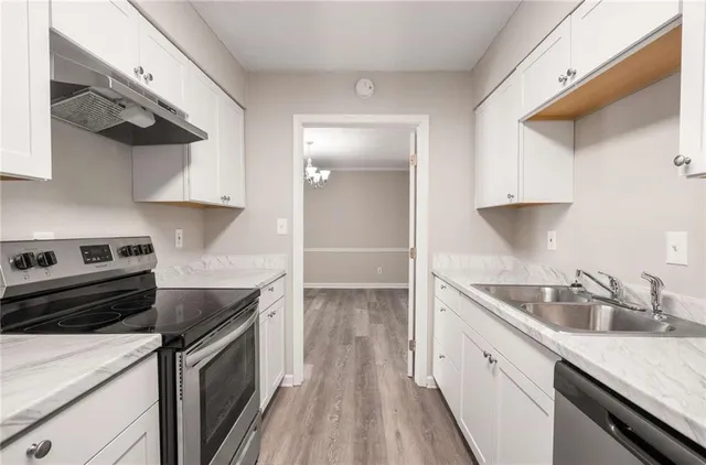 a kitchen that has a sink and a stove