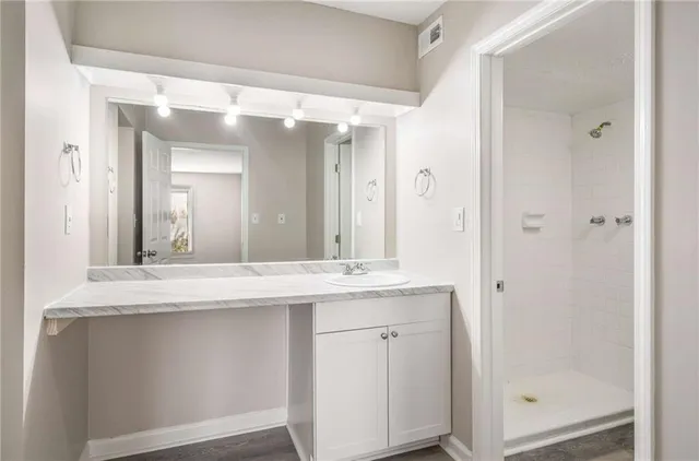 a bathroom with a granite countertop sink mirror and a