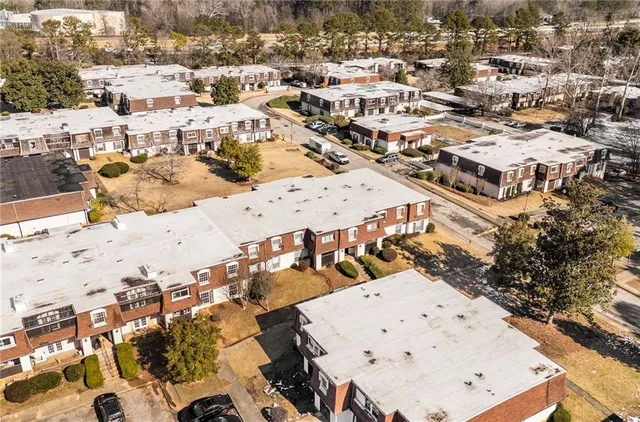 an aerial view of residential houses with outdoor space