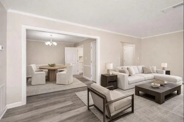 a living room with furniture and view of kitchen