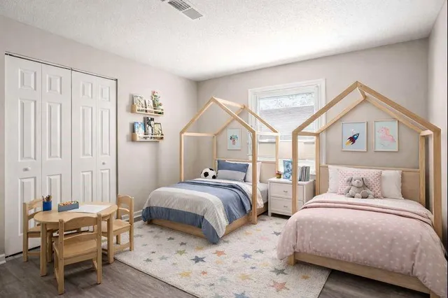 a bedroom with two beds and a chandelier