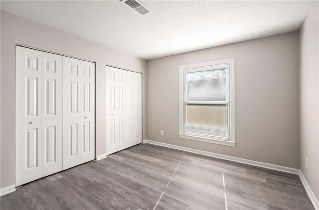 an empty room with a empty space and windows