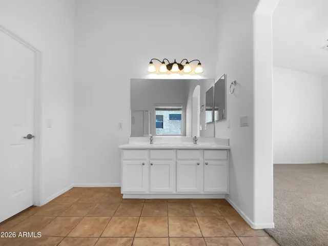 an empty room with a window and a ceiling fan