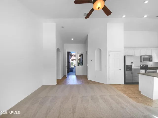a kitchen with stainless steel appliances kitchen island granite countertop a refrigerator and a sink