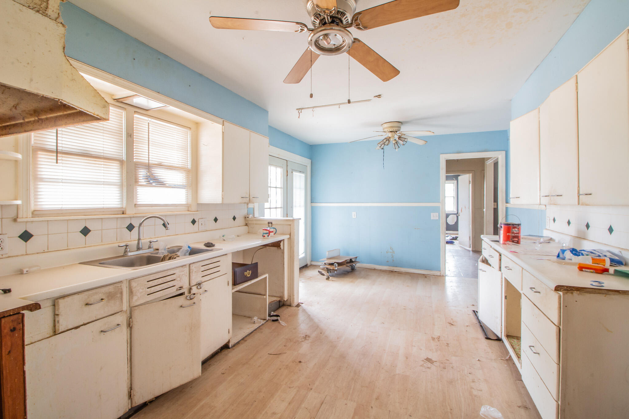 1606 60th Street Lubbock, TX 79412 - Photo 6 of 12 a kitchen with a sink appliances cabinets and a large window