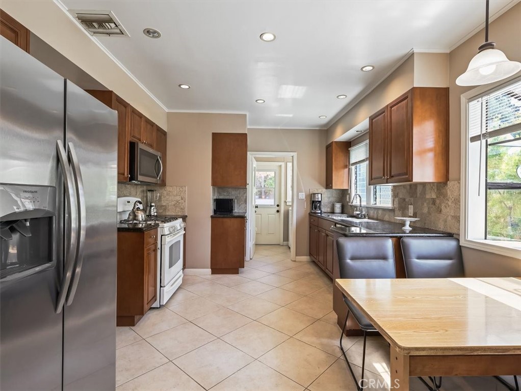945 Rosemount Road Glendale, CA 91207 - Photo 18 of 31 a large kitchen with stainless steel appliances lots of counter space and breakfast area