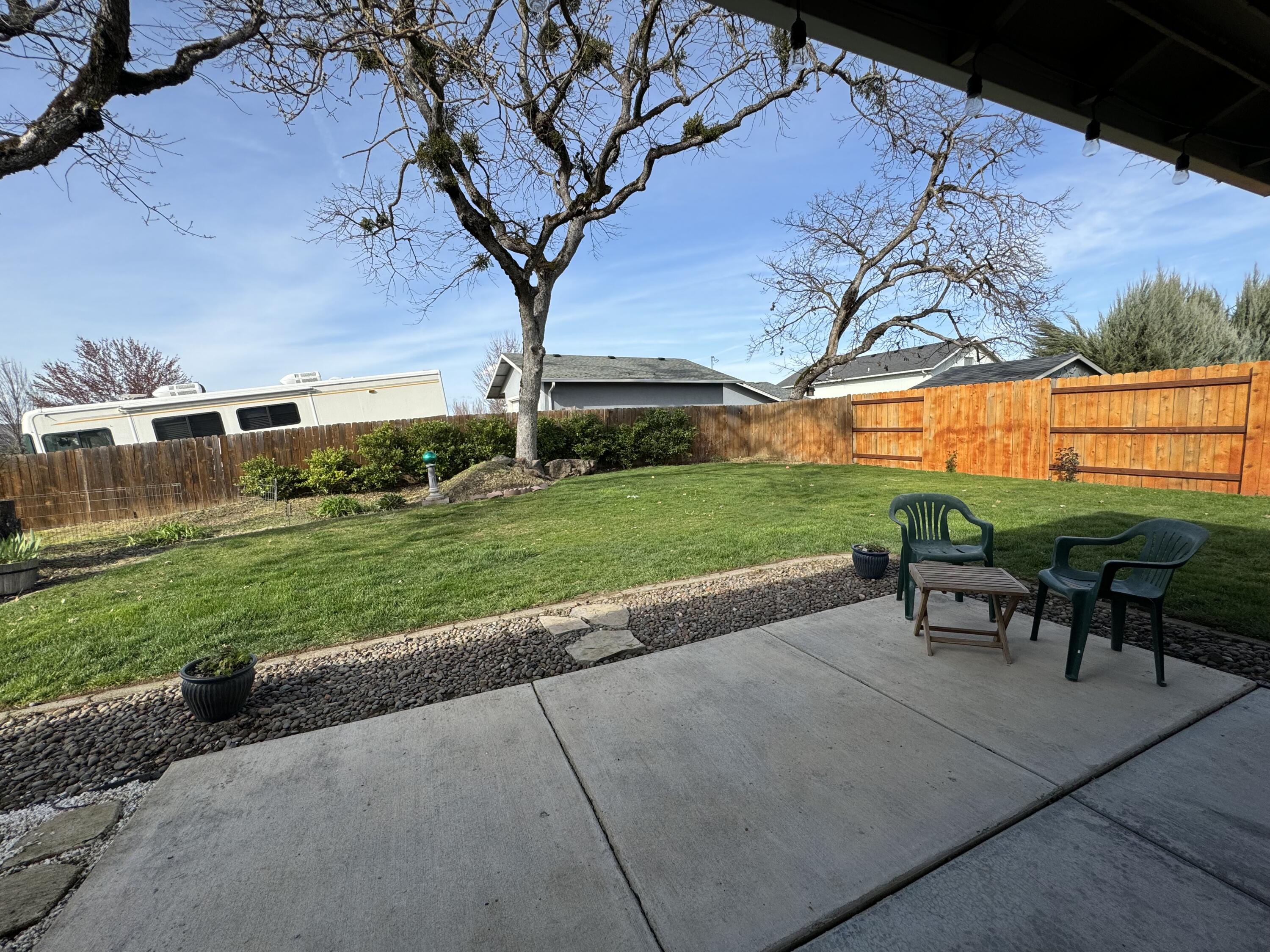 896 Ridgeview Drive Eagle Point, OR 97524 - Photo 12 of 17 a view of a patio with a table chairs and a backyard