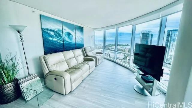 a living room with furniture windows and a flat screen tv