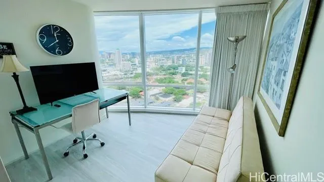 a view of workspace with furniture and large window