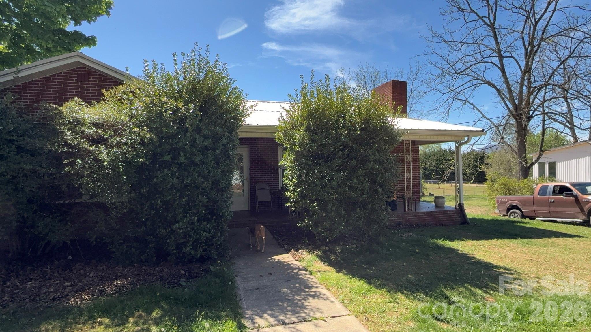 a view of a house with garden and pathway