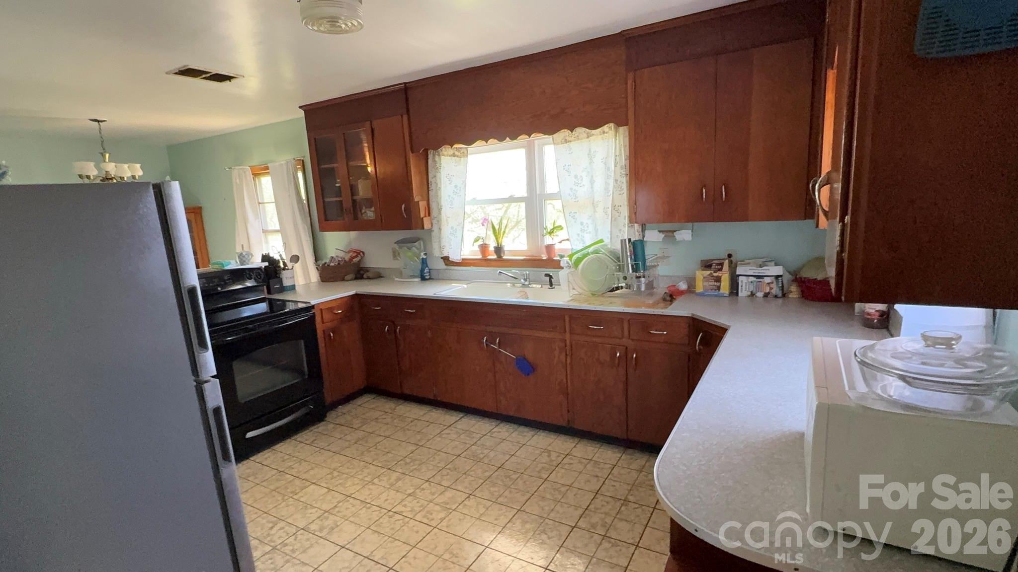 1582 Dutch Cove Road Canton, NC 28716 - Photo 14 of 47 a kitchen with granite countertop a sink stove and refrigerator