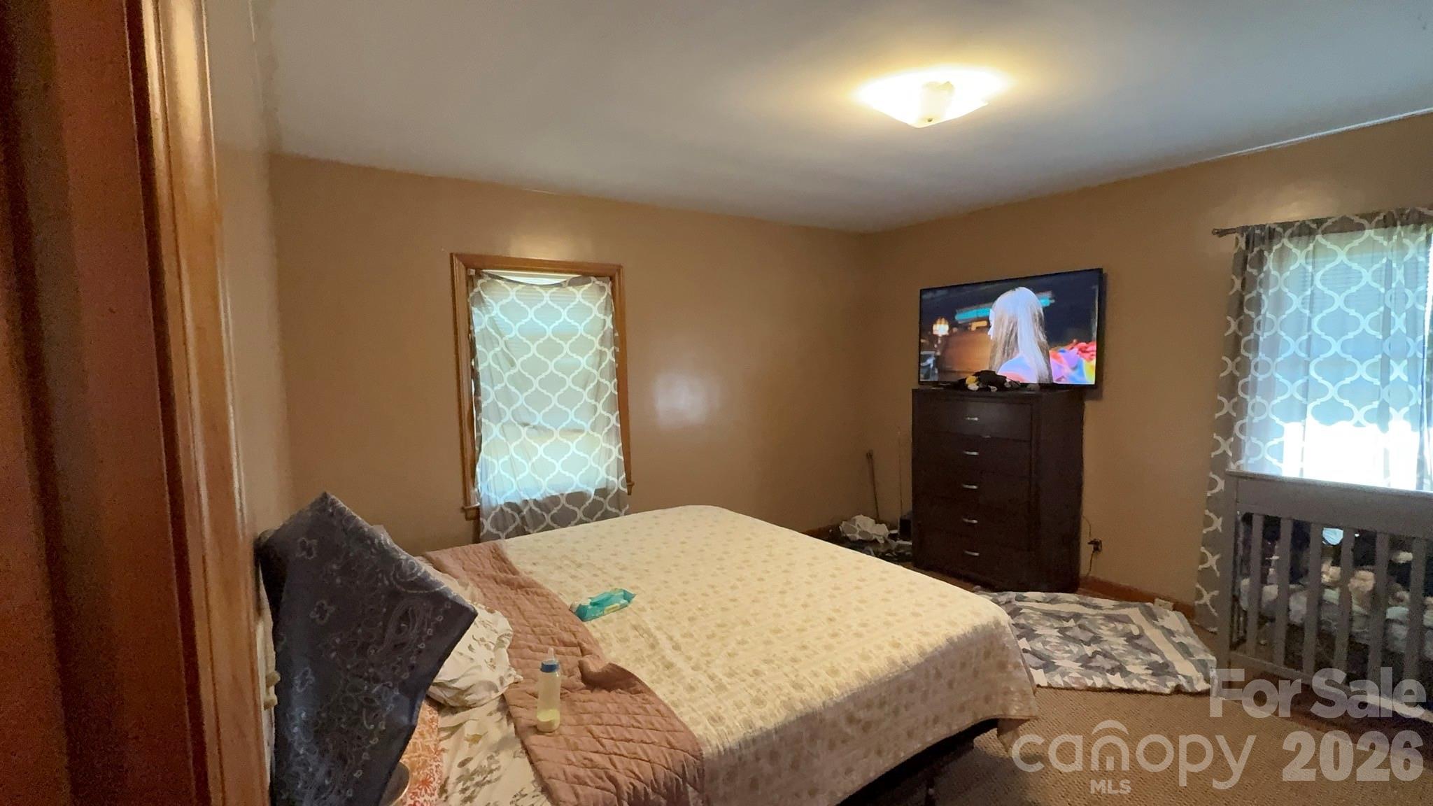 1582 Dutch Cove Road Canton, NC 28716 - Photo 27 of 47 a bedroom with a bed and a television