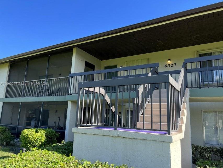 6327 Chasewood Drive, Unit G Jupiter, FL 33458 - Photo 1 of 35 a view of a small house with wooden deck