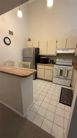a kitchen with a sink a stove and cabinets