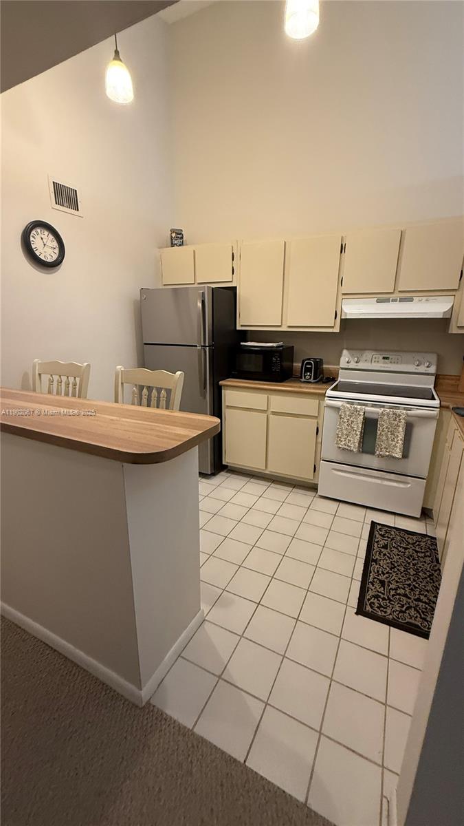 6327 Chasewood Drive, Unit G Jupiter, FL 33458 - Photo 13 of 35 a kitchen with a sink a stove and cabinets