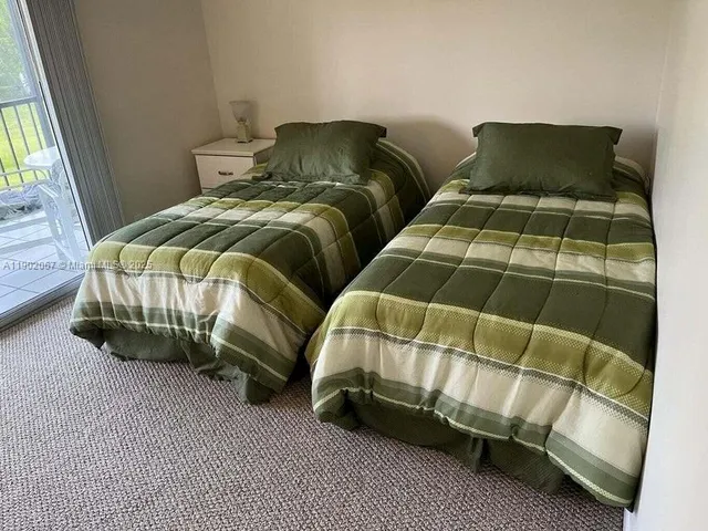 a bedroom with two beds and a window