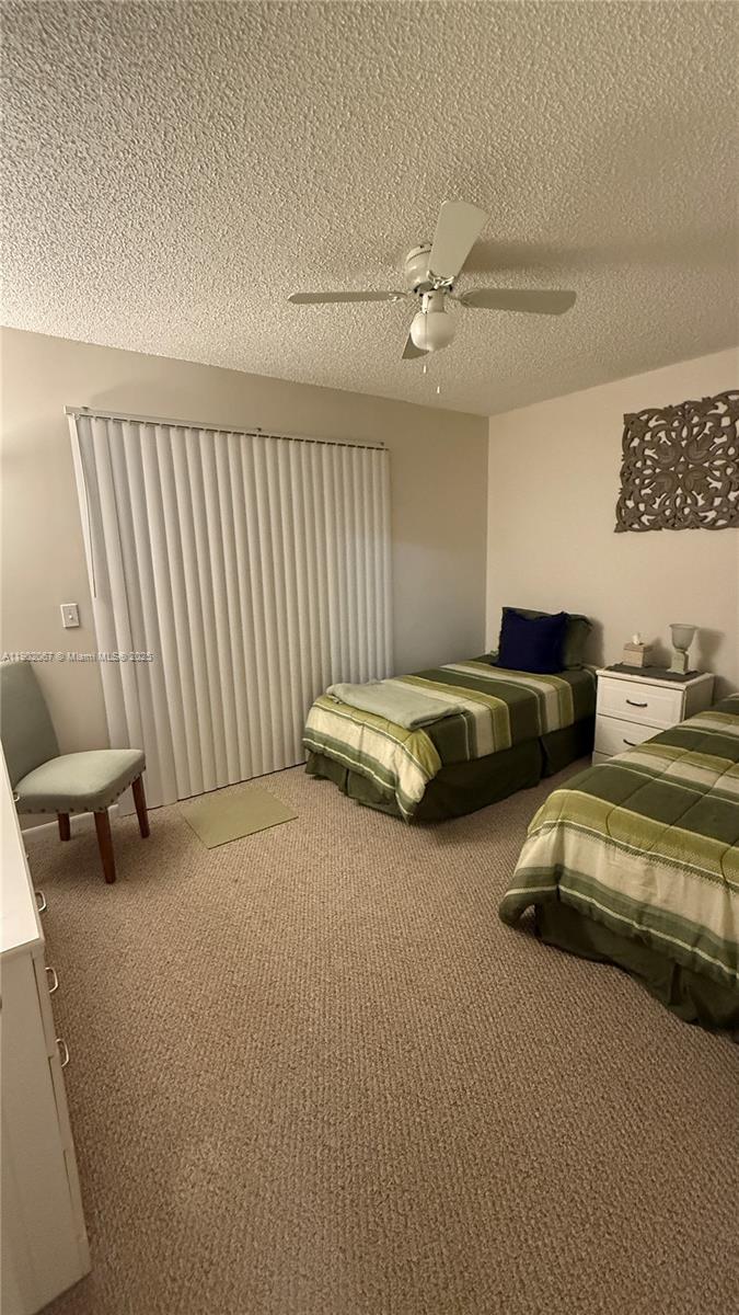 6327 Chasewood Drive, Unit G Jupiter, FL 33458 - Photo 16 of 35 a bedroom with bed and a couch
