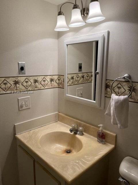 6327 Chasewood Drive, Unit G Jupiter, FL 33458 - Photo 18 of 35 a bathroom with a sink and a mirror
