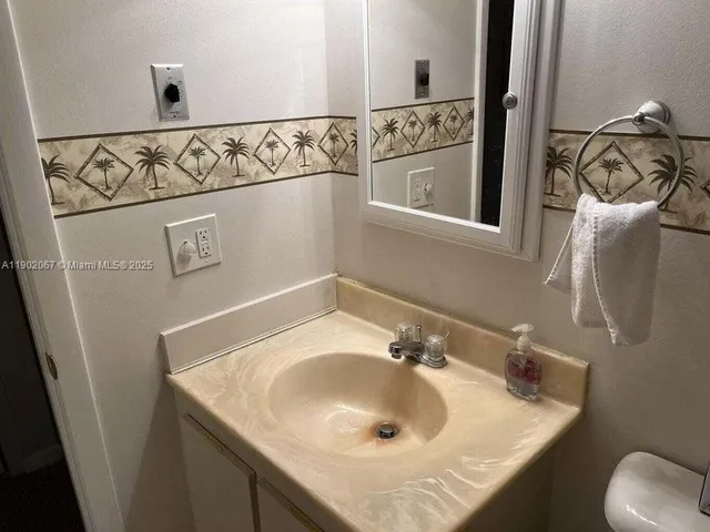 a bathroom with a sink and mirror