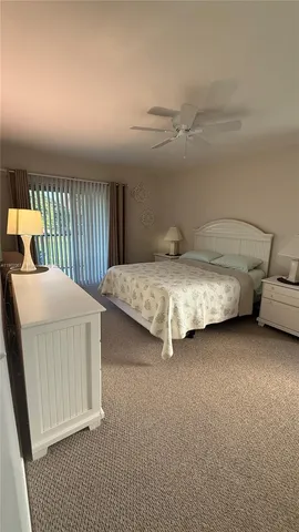 a bed room with a bed and a chair