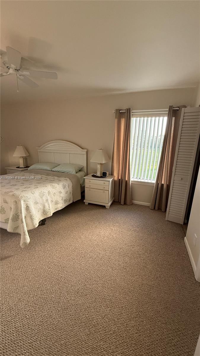 6327 Chasewood Drive, Unit G Jupiter, FL 33458 - Photo 23 of 35 a bed room with a bed and a chair