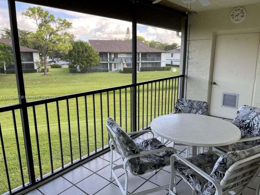 6327 Chasewood Drive, Unit G Jupiter, FL 33458 - Photo 34 of 35 a view of a chairs and table in the balcony