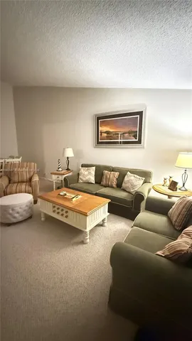 a living room with furniture and a lamp