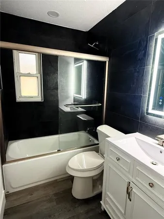 a bathroom with a toilet a sink and bathtub