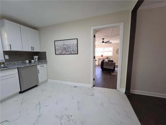 a view of a kitchen with a sink cabinets and a window