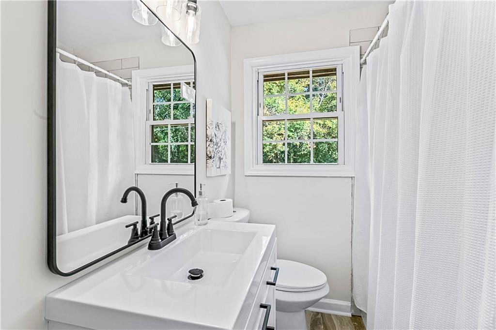 1576 South Gordon Road Southwest Austell, GA 30168 - Photo 19 of 33 a bathroom with a sink a toilet and a mirror