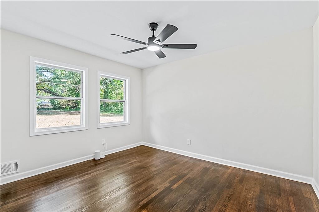 1576 South Gordon Road Southwest Austell, GA 30168 - Photo 20 of 33 an empty room with wooden floor fan and windows