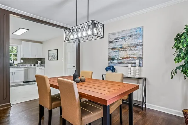 a view of a dining room with furniture wooden floor and chandelier