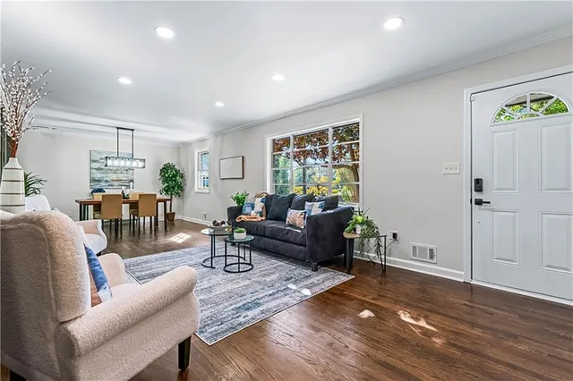 a living room with furniture and wooden floor