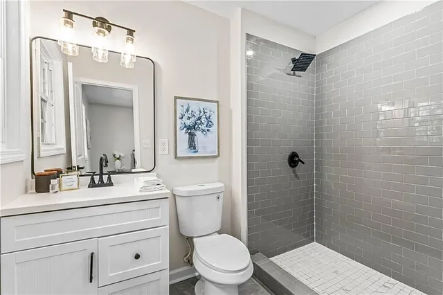 a bathroom with a toilet a sink and shower