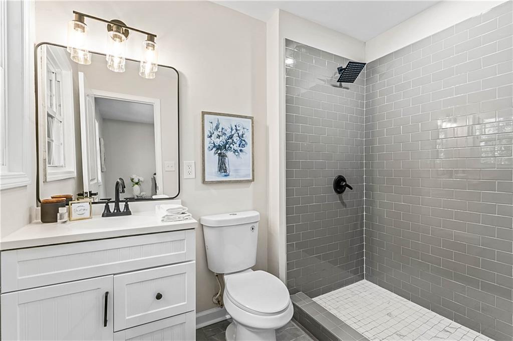 1576 South Gordon Road Southwest Austell, GA 30168 - Photo 3 of 33 a bathroom with a toilet a sink and shower