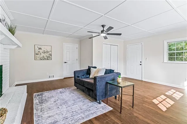 a living room with furniture and wooden floor