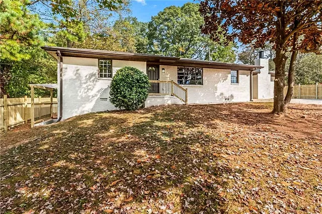 front view of a house with a large tree