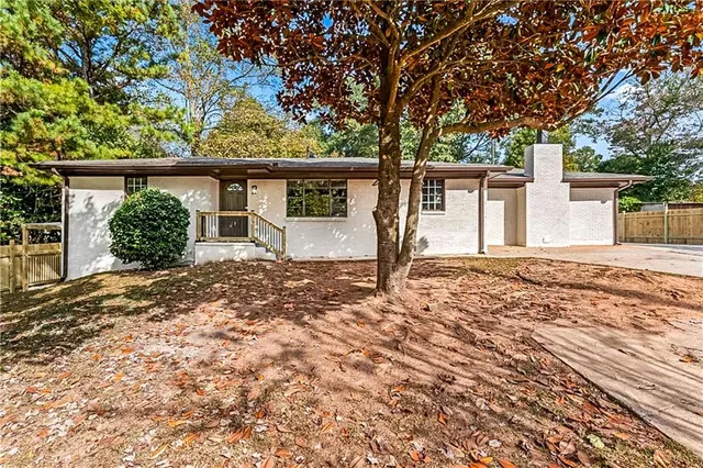 front view of a house with a large tree