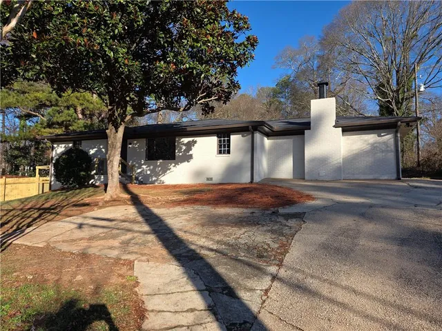 a view of a house with snow on the road