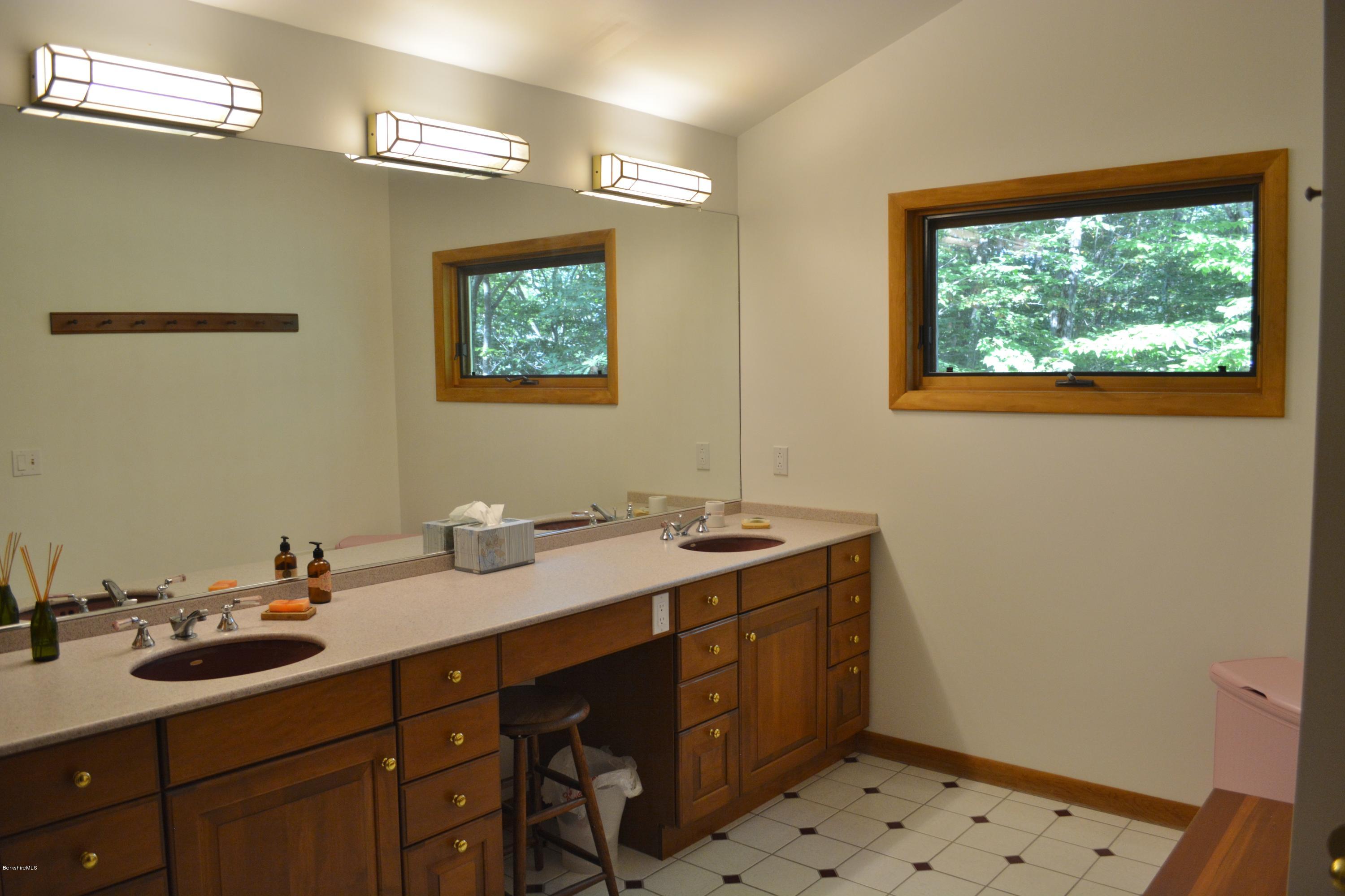 537 Norton Road Otis, MA 01029 - Photo 18 of 25 a bathroom with a sink mirror and a shower