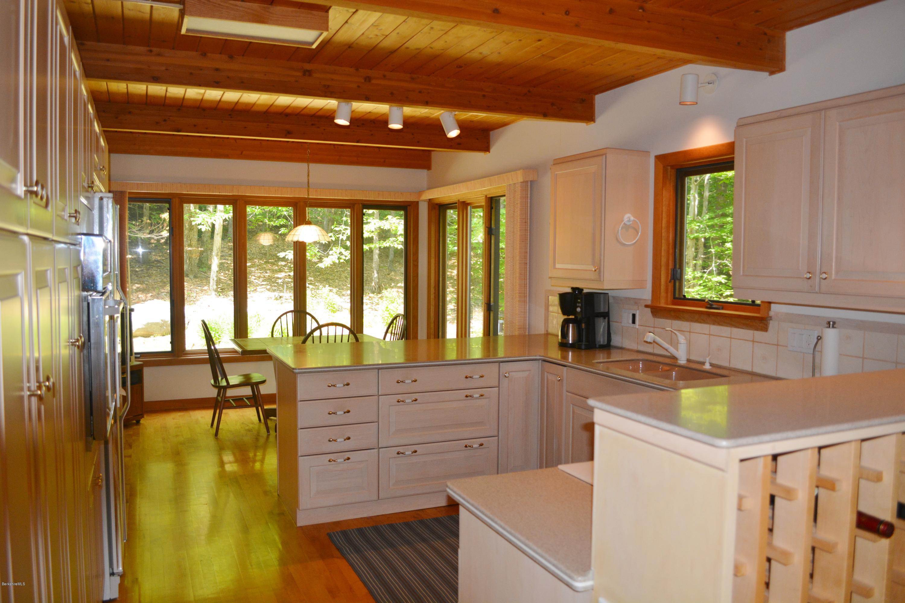 537 Norton Road Otis, MA 01029 - Photo 3 of 25 a kitchen with a refrigerator a sink and cabinets